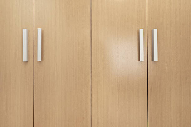 istock Light wood cabinet doors and gray metal handles 2242007366