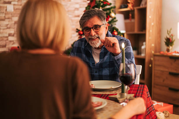 istock Senior couple enjoying christmas candlelight dinner at home 2242007931