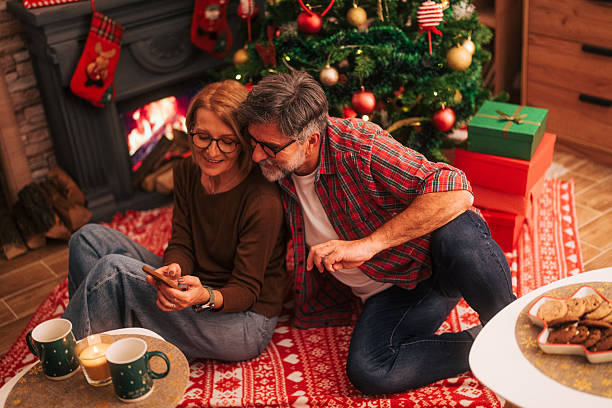 istock Senior couple using smartphone during christmas celebration 2242008051
