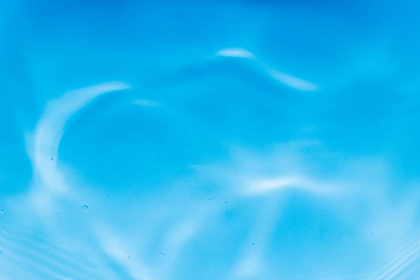 Reflecting water wave abstract surface on a sunny day and natural swirl texture, summer background. Water surface in vibrant blue. Abstract of water in swimming pool.