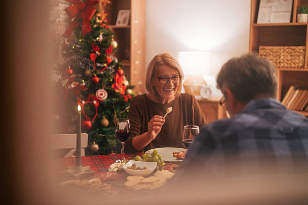 istock Senior couple enjoying christmas dinner with red wine 2242010349