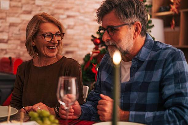 istock Senior couple sharing happy moments laughing during christmas dinner 2242010514