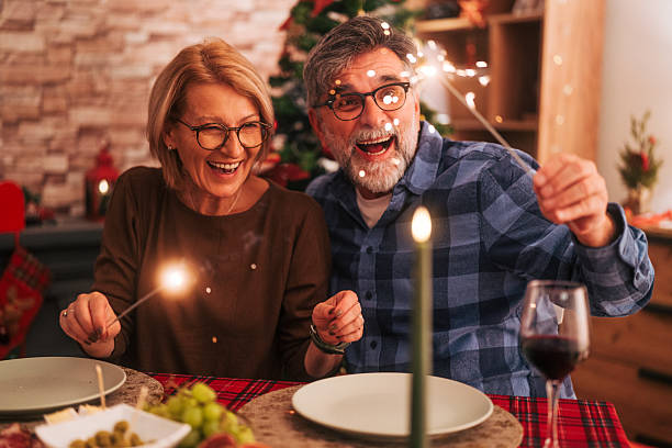 istock Senior couple celebrating holiday dinner with sparklers 2242011836