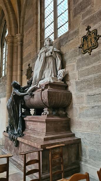 istock A beautiful statue of a bishop praying with Mary Magdalena (Dijon Cathedral, France) 2242011949