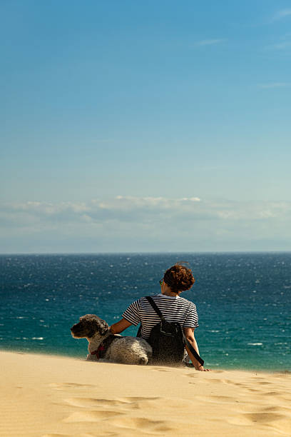 istock Woman with pet enjoying the beach in Tarifa 2242017500