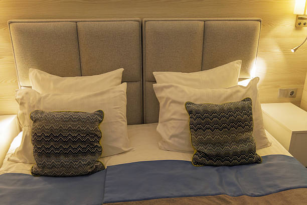 istock King Bed with Pillows and Warm Lighting in Hotel Room 2242017662