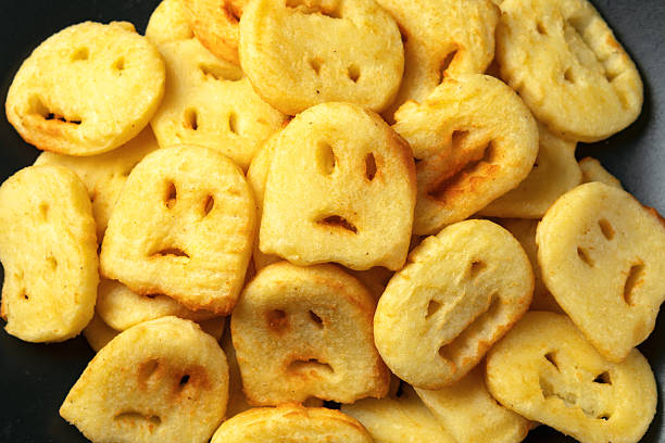 Fried Halloween potato shapes on black plate