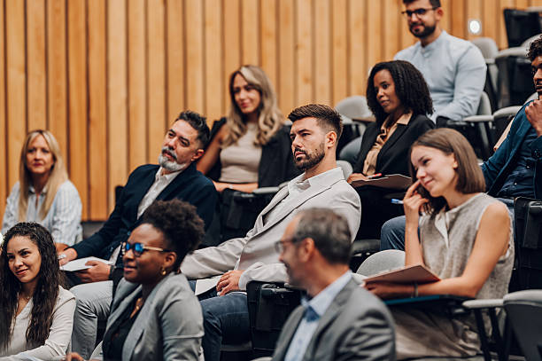 istock Diverse business professionals attending conference and learning 2242026234