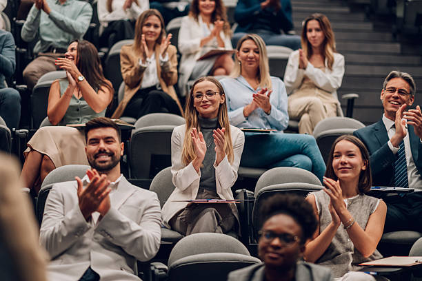 istock Diverse audience clapping at business conference 2242027515