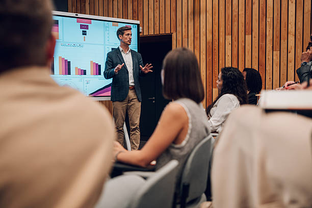 istock Businessman giving presentation in front of audience 2242027630