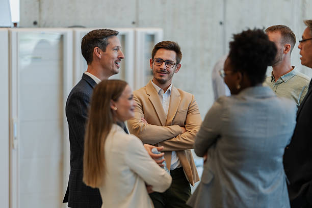 istock Business colleagues networking and discussing at corporate event 2242027711