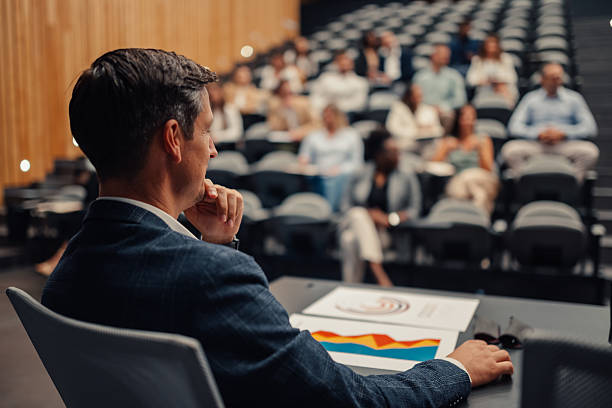 istock Business professional attending conference presentation in auditorium 2242027789