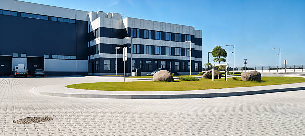 istock Modern industrial building with a landscaped area on a sunny day. 2242029964
