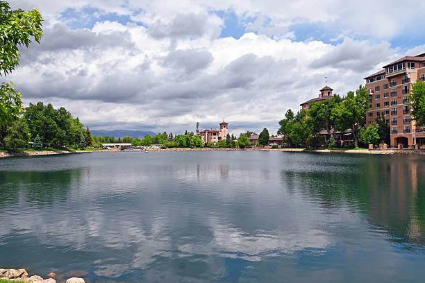 istock A hotel by a pond with clouds reflection on the water 2242031698