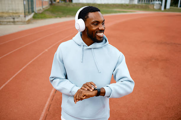 istock Man tracking fitness progress on running track 2242042929