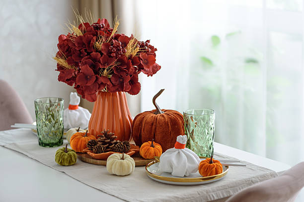 istock Thanksgiving table setting with decorative pumpkins, candles and string lights on white wooden table 2242043020