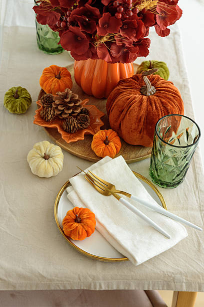 istock Thanksgiving table setting with decorative pumpkins, candles and string lights on white wooden table 2242043034
