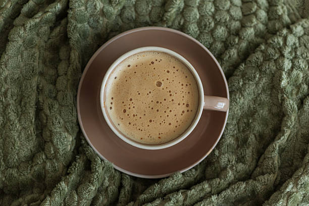 istock Cozy Living Room with Coffee Cup on Green Blanket 2242043211