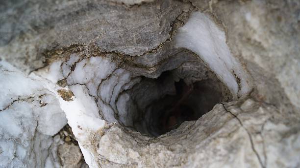istock Dark Hole in a Light Cave Entrance 2242047649