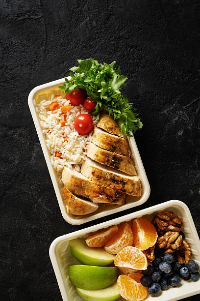 istock Lunch box with chicken, rice, vegetables, tomatoes, salad, fruits 2242049319