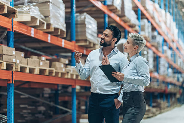 istock Business persons organizing the export containers in a warehouse 2242051876