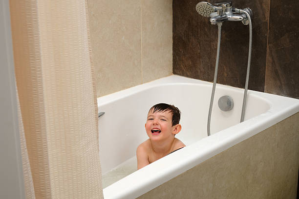 istock Little boy with a happy expression on his face taking a bath. Child having fun during daily hygiene routine. Kid playtime. Child aged 4 years (four years old) 2242058443