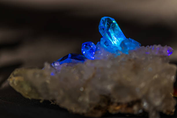 istock Natural quartz crystals glowing in blue prism light 2242058542