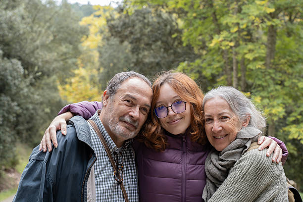 istock Parents and daughter hugging and smiling during a walk in nature. 2242060087