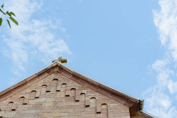 istock Stone Church Facade Against Bright Blue Sky 2242065806