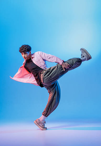 istock Bboy high kick in neon studio with copy space for youth music promos 2242070316
