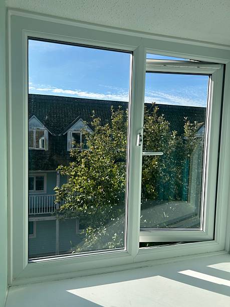 istock Bright White Window View From Inside A Sunlit Room Overlooking Trees And Neighboring Houses 2242071820
