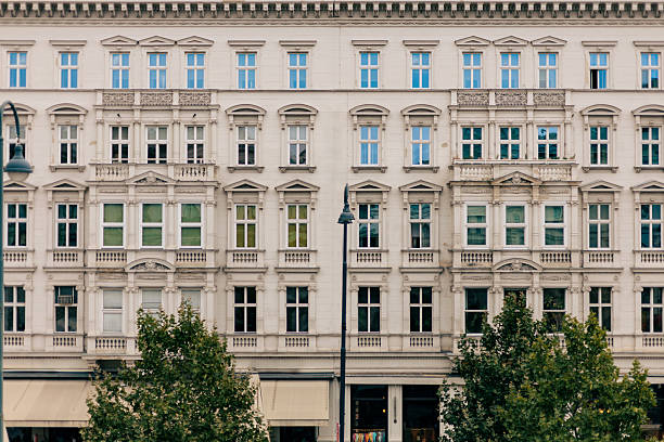 Front view of a grand European building featuring ornate stonework, tall windows, and balanced architectural symmetry. Captured in soft daylight, the composition emphasizes structure, rhythm, and texture, blending classical design with urban elegance. The scene conveys timeless architecture grounded in realism