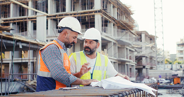 istock Civil engineer, and foreman are discussing on the progress plan and the project at construction site 2242074920