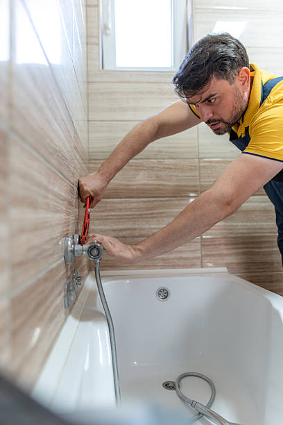 istock Plumber repairs bathtub faucet in modern bathroom during daylight hours 2242076422