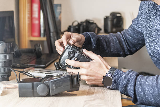 istock A photographer cleaning his equipment on an office table 2242078068