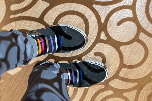 A gentleman's feet dressed in unmarked sneakers