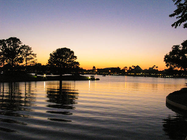 Sunset over the lake with reflections and trees.