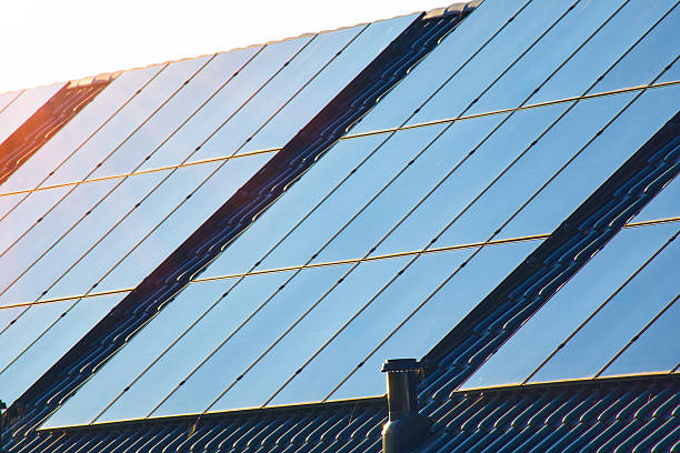 istock A close-up view of rooftop solar panels on a tiled house, capturing sunlit reflections 2242082049