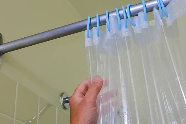 istock Hand adjusting clear shower curtain rings 2242083322