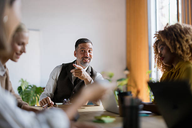 istock Diverse business team collaborating and laughing in office meeting 2242083689