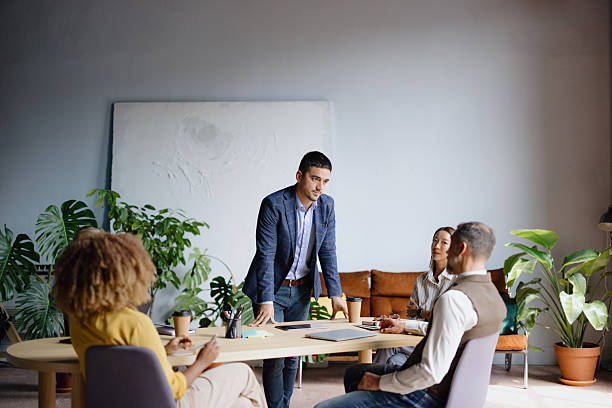 istock Business professional leading meeting with diverse team 2242083773