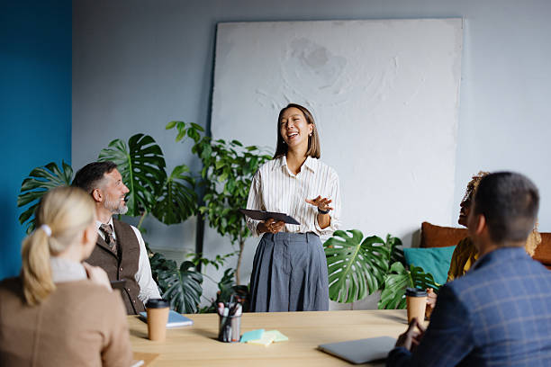 istock Woman presenting project to diverse business team in office 2242083777