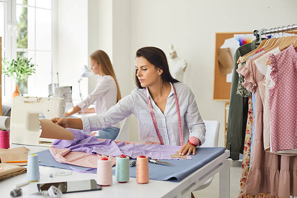 istock Woman designer work with fabric in atelier 2242085284