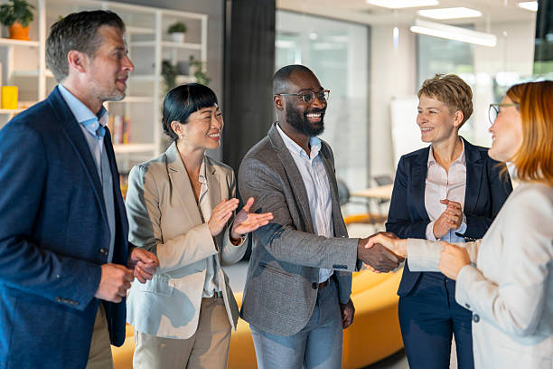 istock Business people shaking hands congratulating new partner in office 2242089436