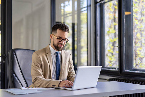 istock Professional man working at a laptop in a modern office 2242090339