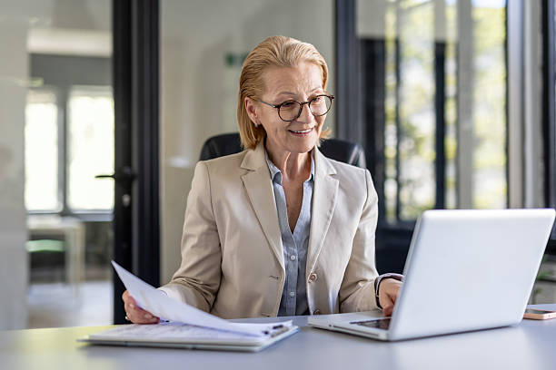 istock Professional Elderly Woman Working on Laptop in Office 2242090341