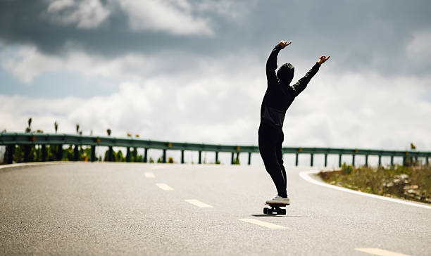 istock Skateboarder skateboarding on the mountain road 2242090809