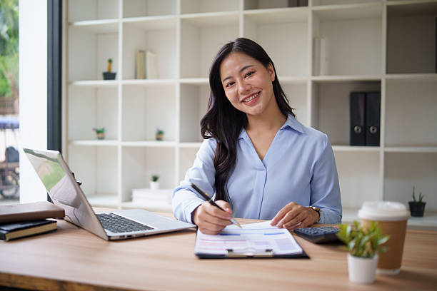 istock Female entrepreneur managing business finances and using laptop at modern office. 2242091465