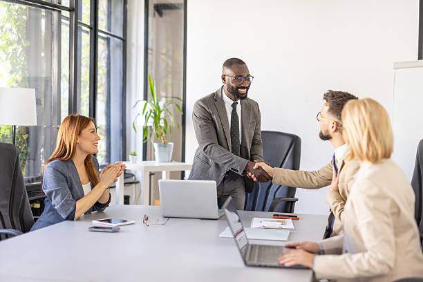istock Positive Team Environment Highlighted by Smiles and Handoffs 2242093034