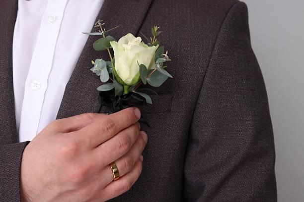 istock Groom with boutonniere on light grey background, closeup. Wedding accessory 2242095757